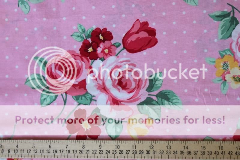Pretty large pink roses on a pink background with polka dot accents